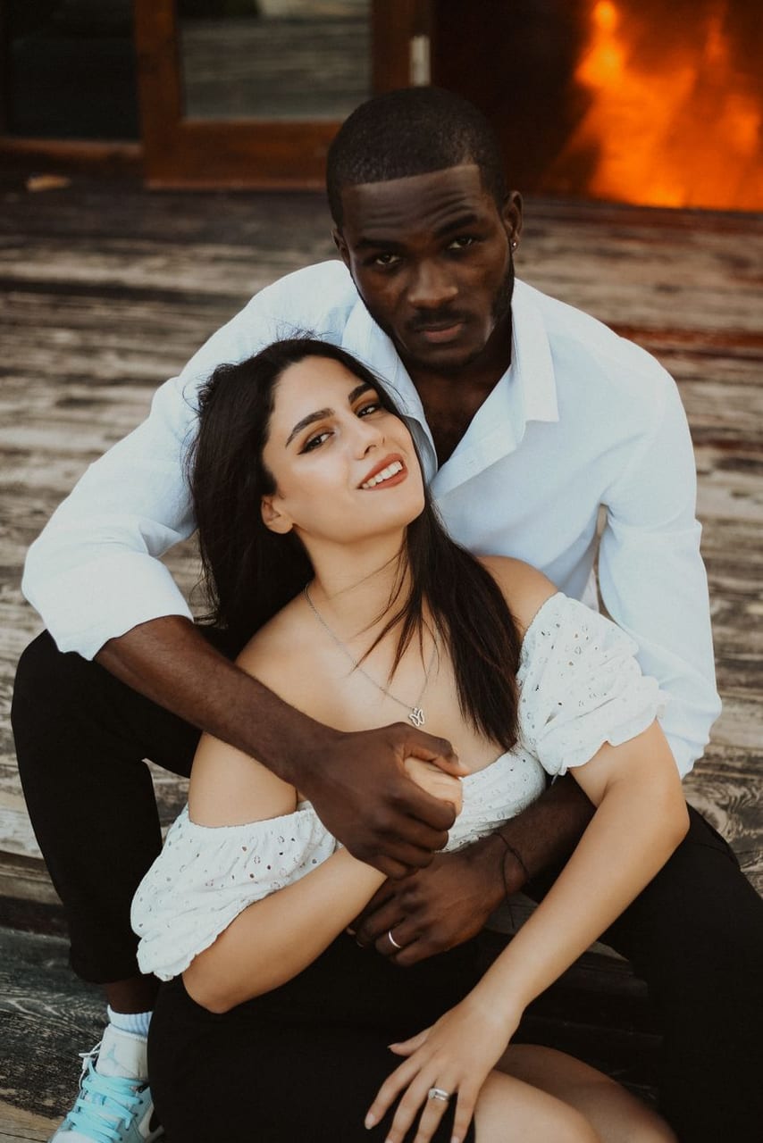 Two partners in a close embrace
