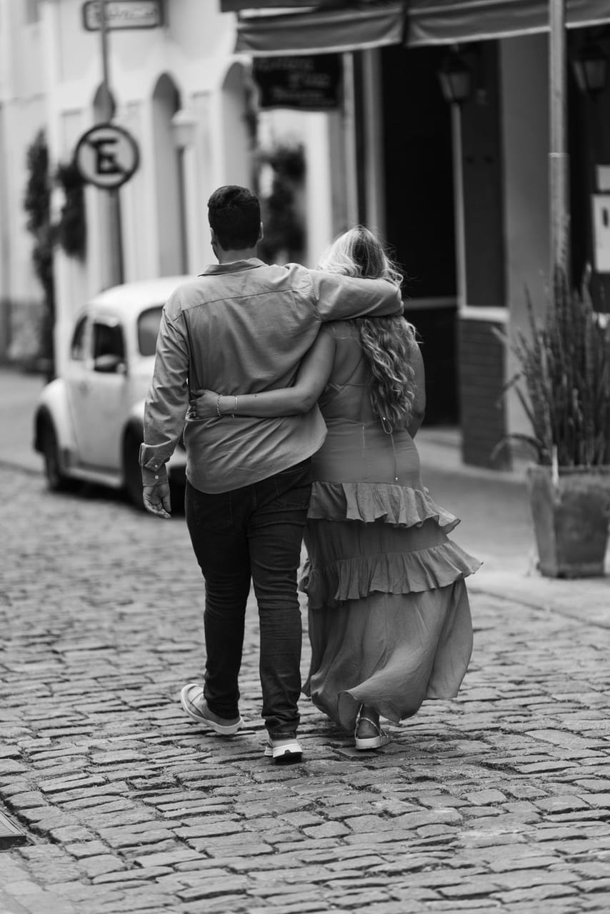 A couple walking arm in arm