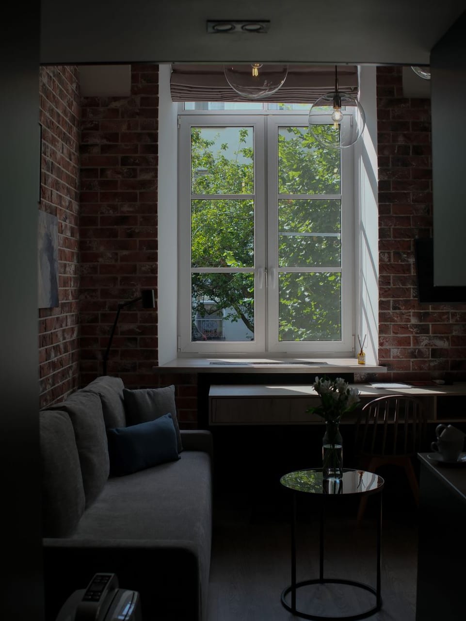 A warm living room with plants and window light