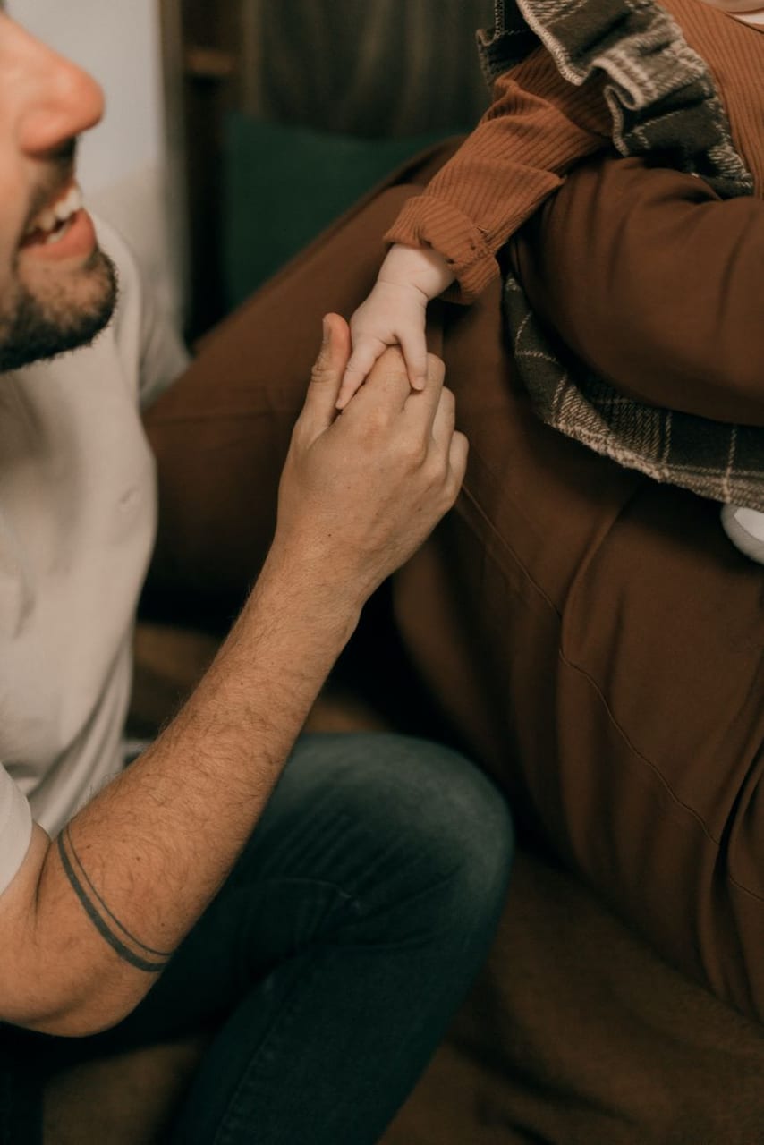 One hand holding another in comfort