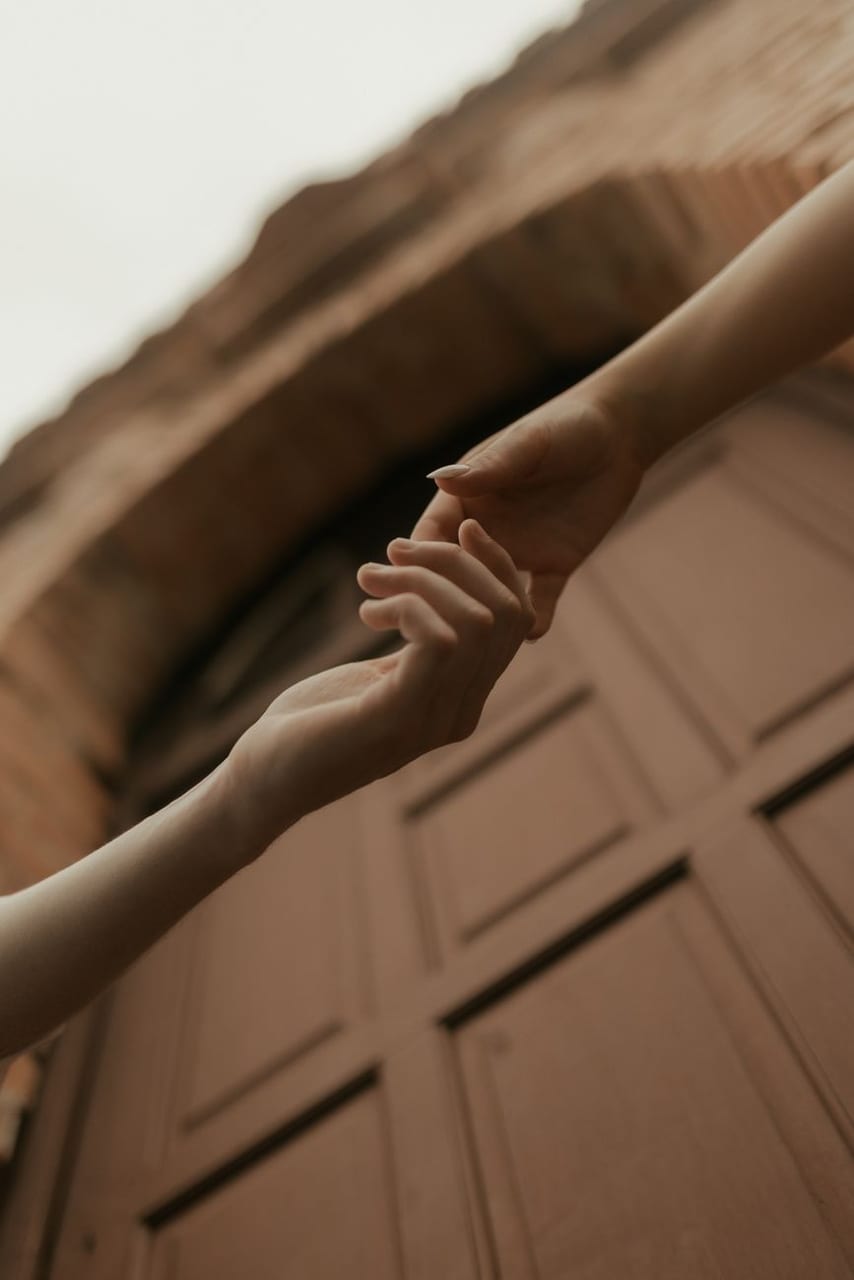 Two hands reaching toward each other