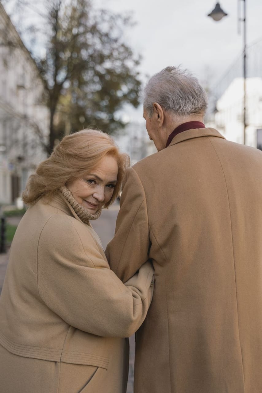 An older couple embracing outdoors in the cool air