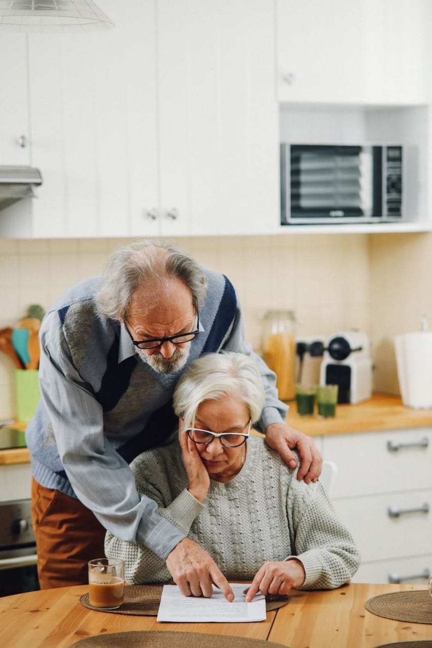An older couple together in their kitchen