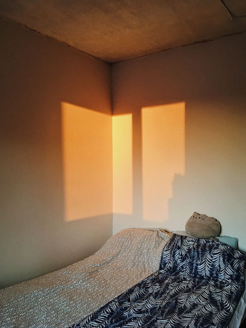 Morning sun across a quiet bedroom